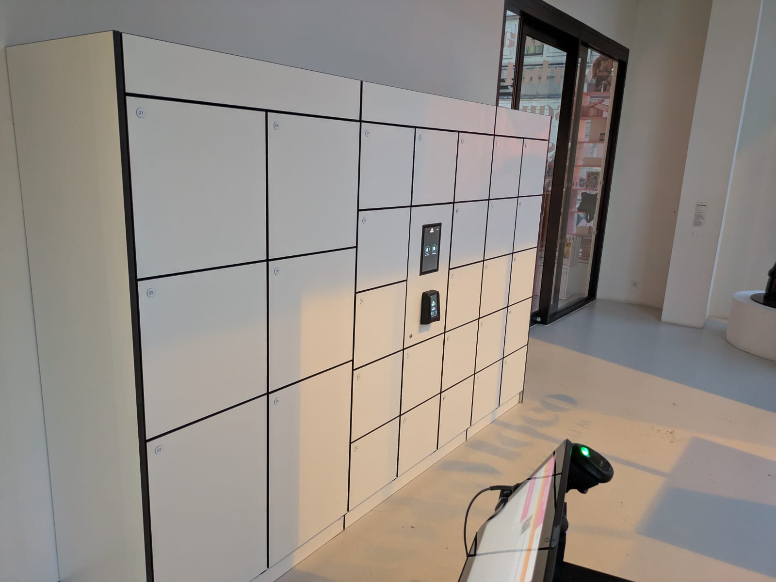 Employee using an access credential at a smart locker reader.